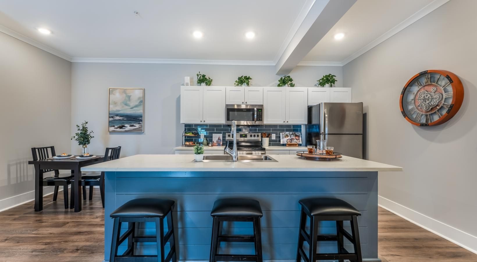 a kitchen with a bar and chairs