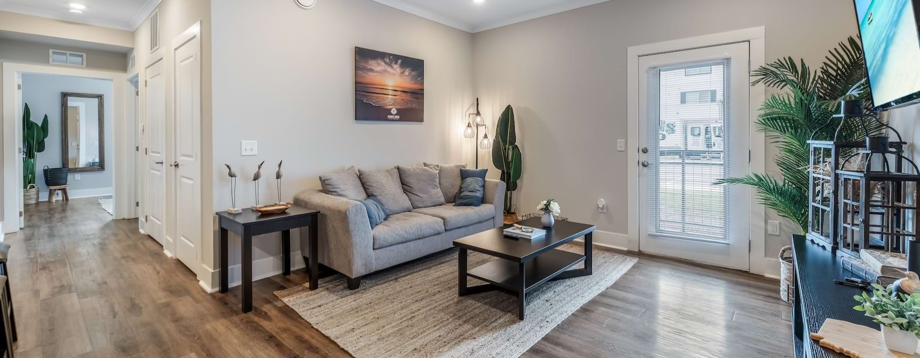 a living room with a couch, tables and a tv