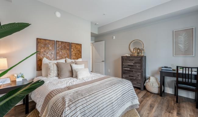 a bedroom with a bed and a desk